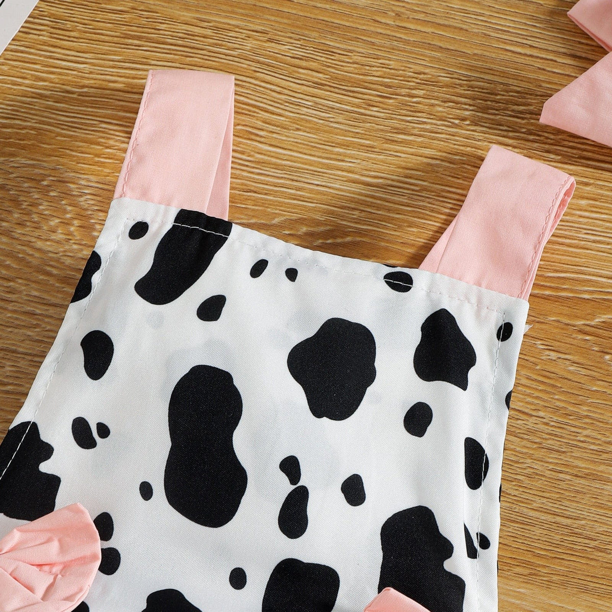 Cow print baby romper